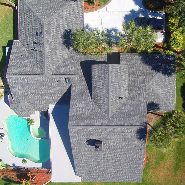 Top view of home roof with gray roofing tiles