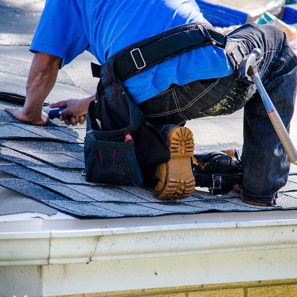 Man installing roof shingles